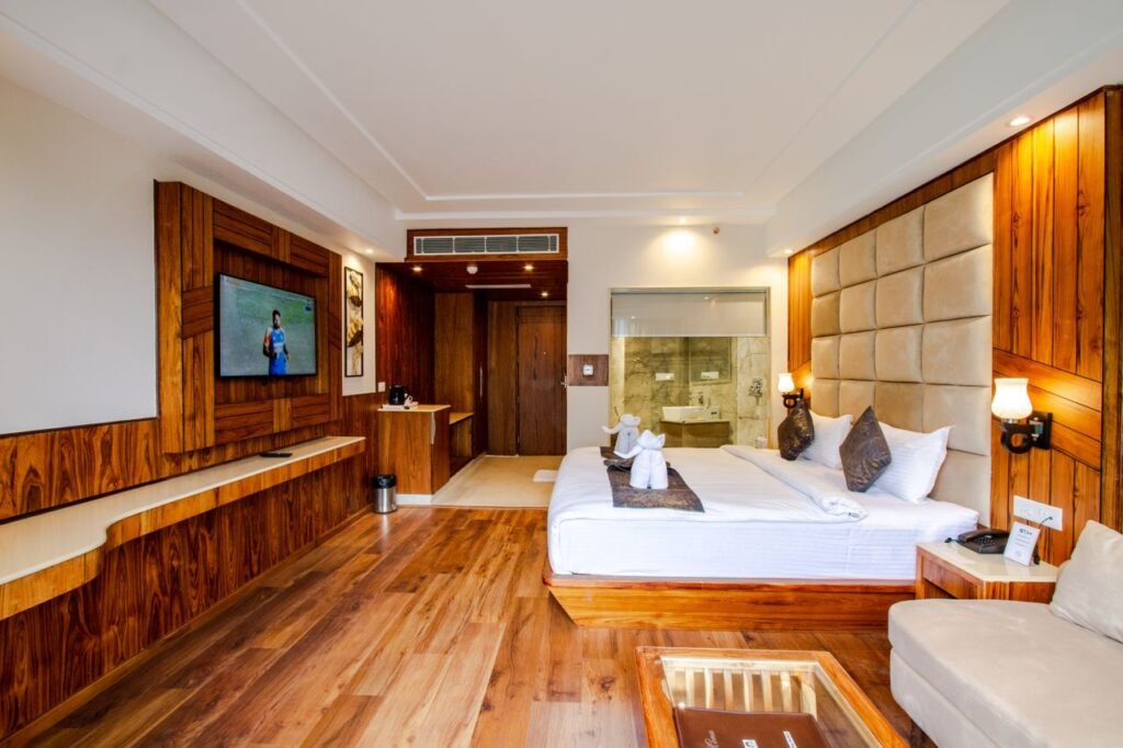 Spacious modern hotel room with rich wood accents and elegant design, ideal for a luxury stay.