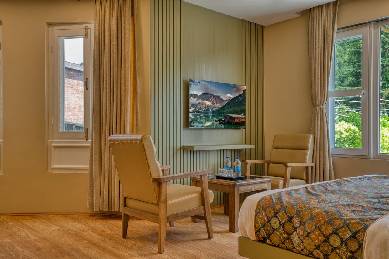 A well-designed modern room with warm tones, featuring a scenic view through large windows.